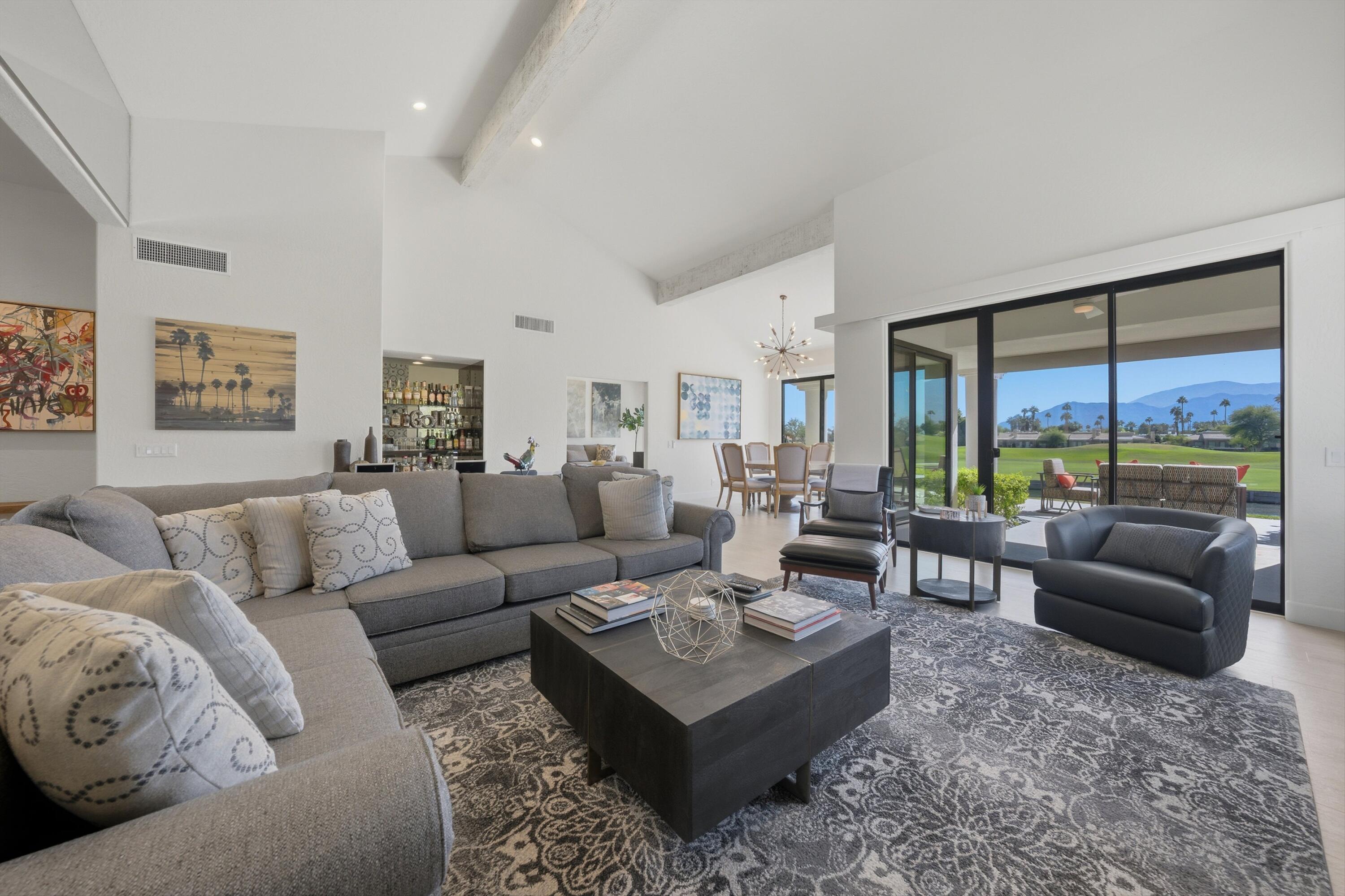 54672 Inverness Way La Quinta, CA 92253 - Photo 14 of 49 a living room with furniture couches and a large window