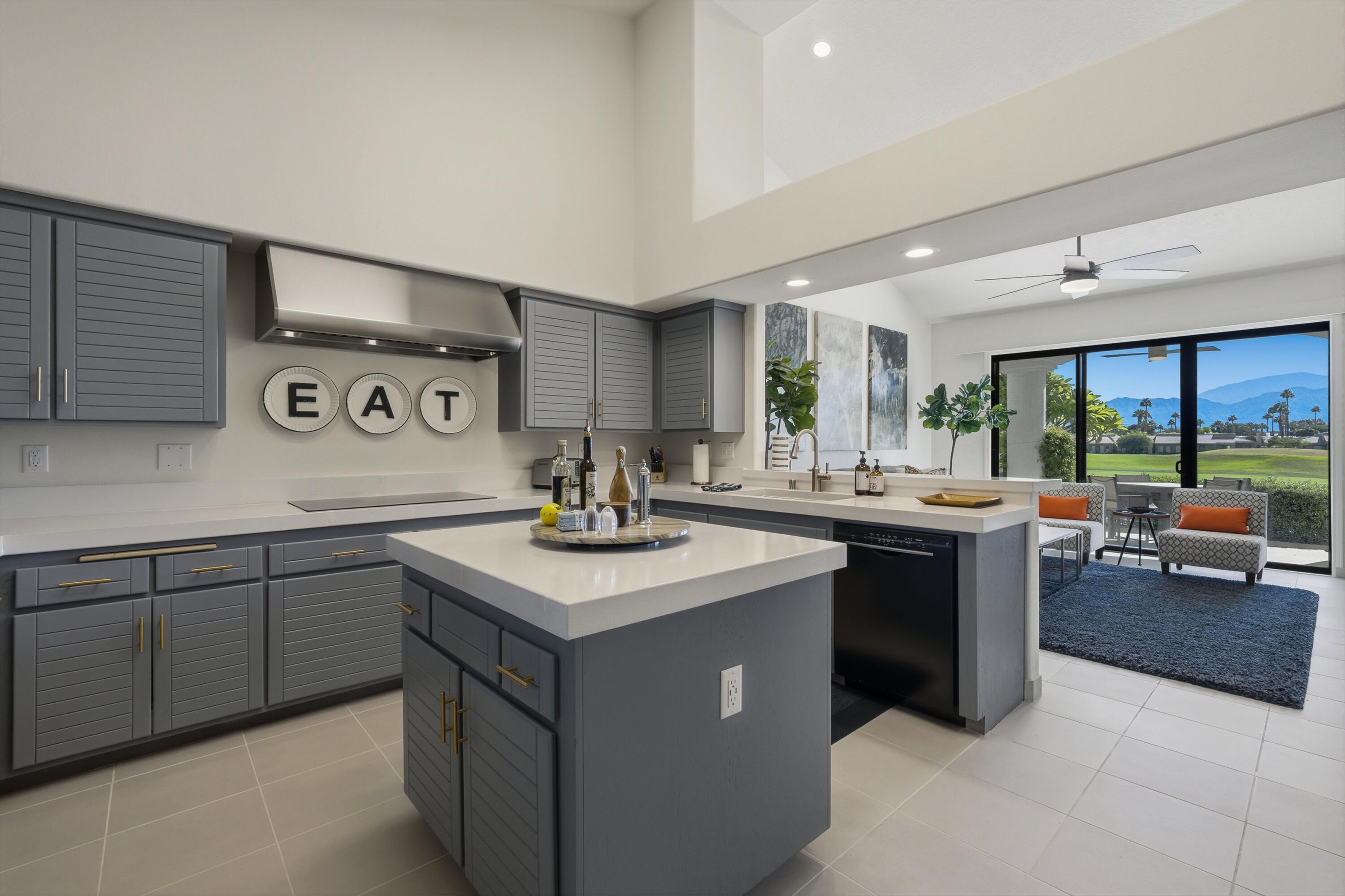 54672 Inverness Way La Quinta, CA 92253 - Photo 21 of 49 a kitchen with stainless steel appliances granite countertop a sink and a stove
