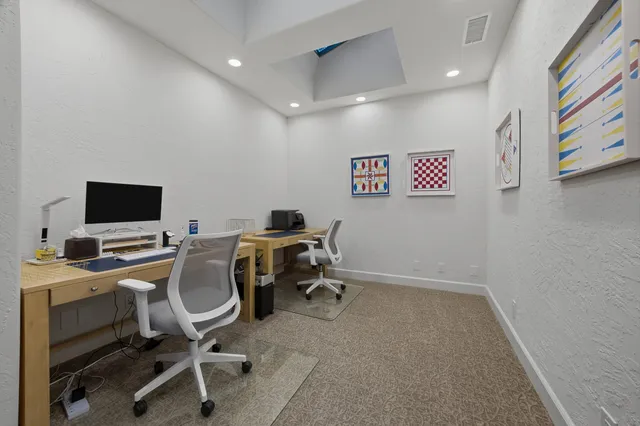 a view of a workspace with furniture