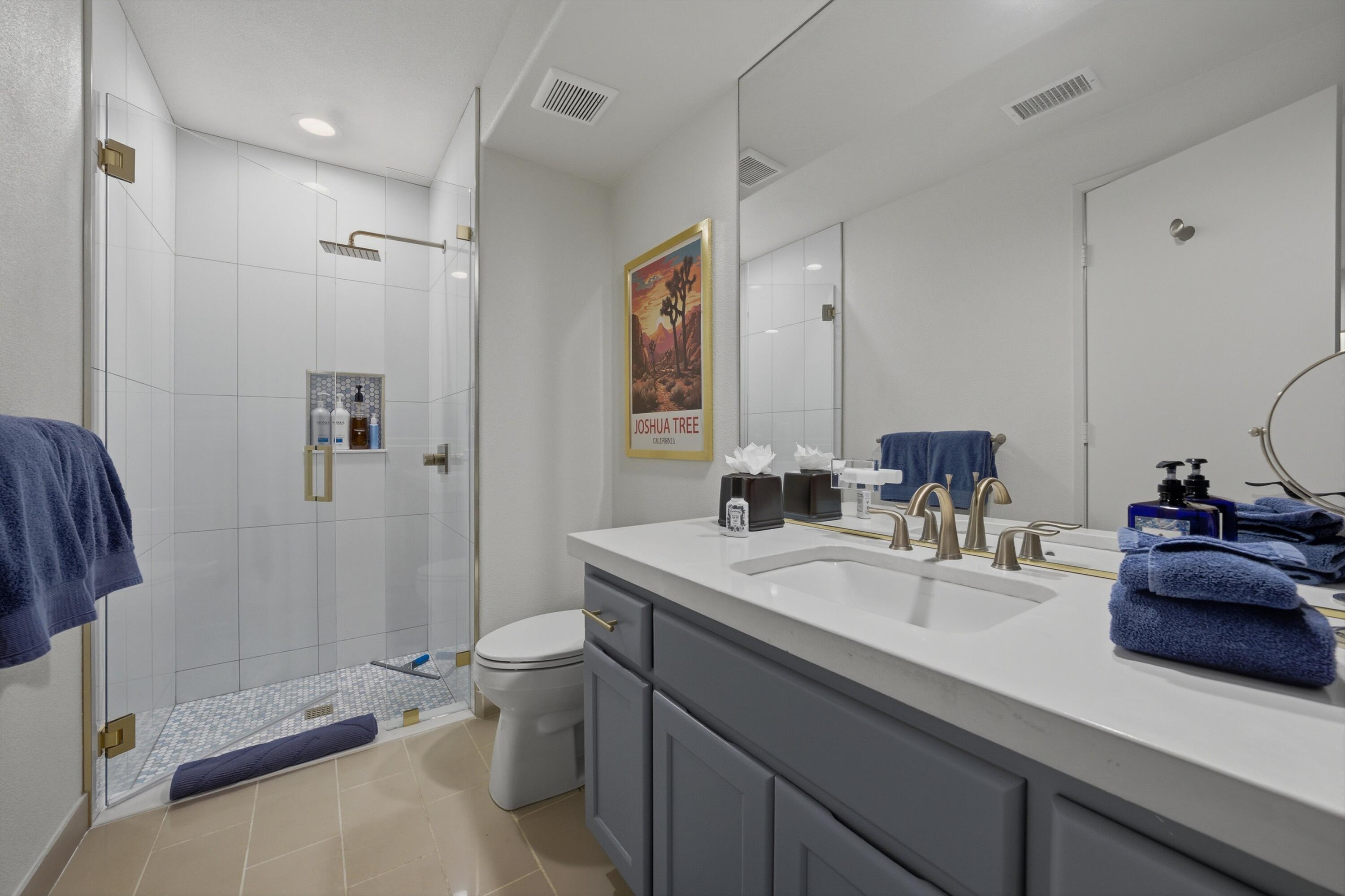 54672 Inverness Way La Quinta, CA 92253 - Photo 26 of 49 a bathroom with a double vanity sink toilet and shower