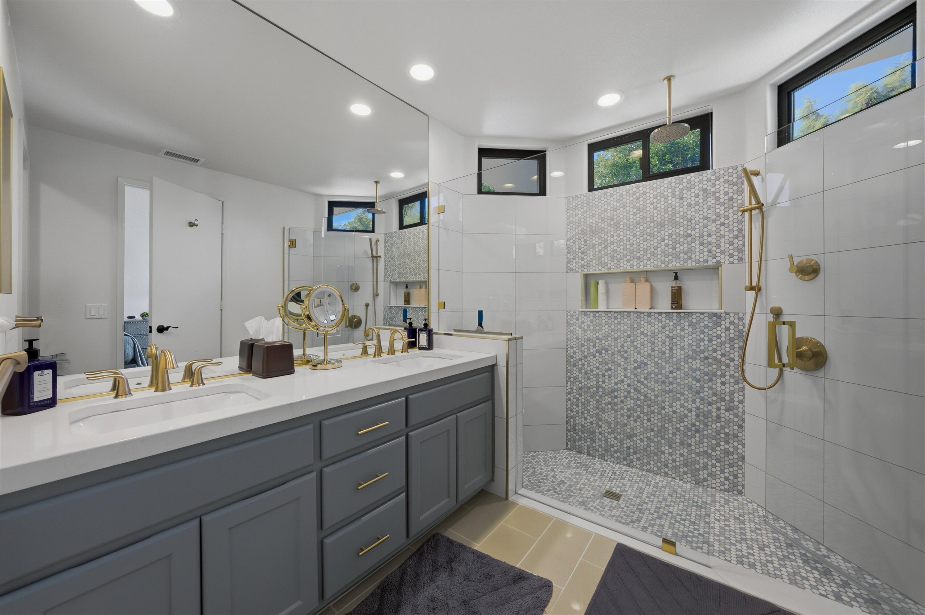 54672 Inverness Way La Quinta, CA 92253 - Photo 30 of 49 a en suite bathroom with a double vanity sink a mirror and shower