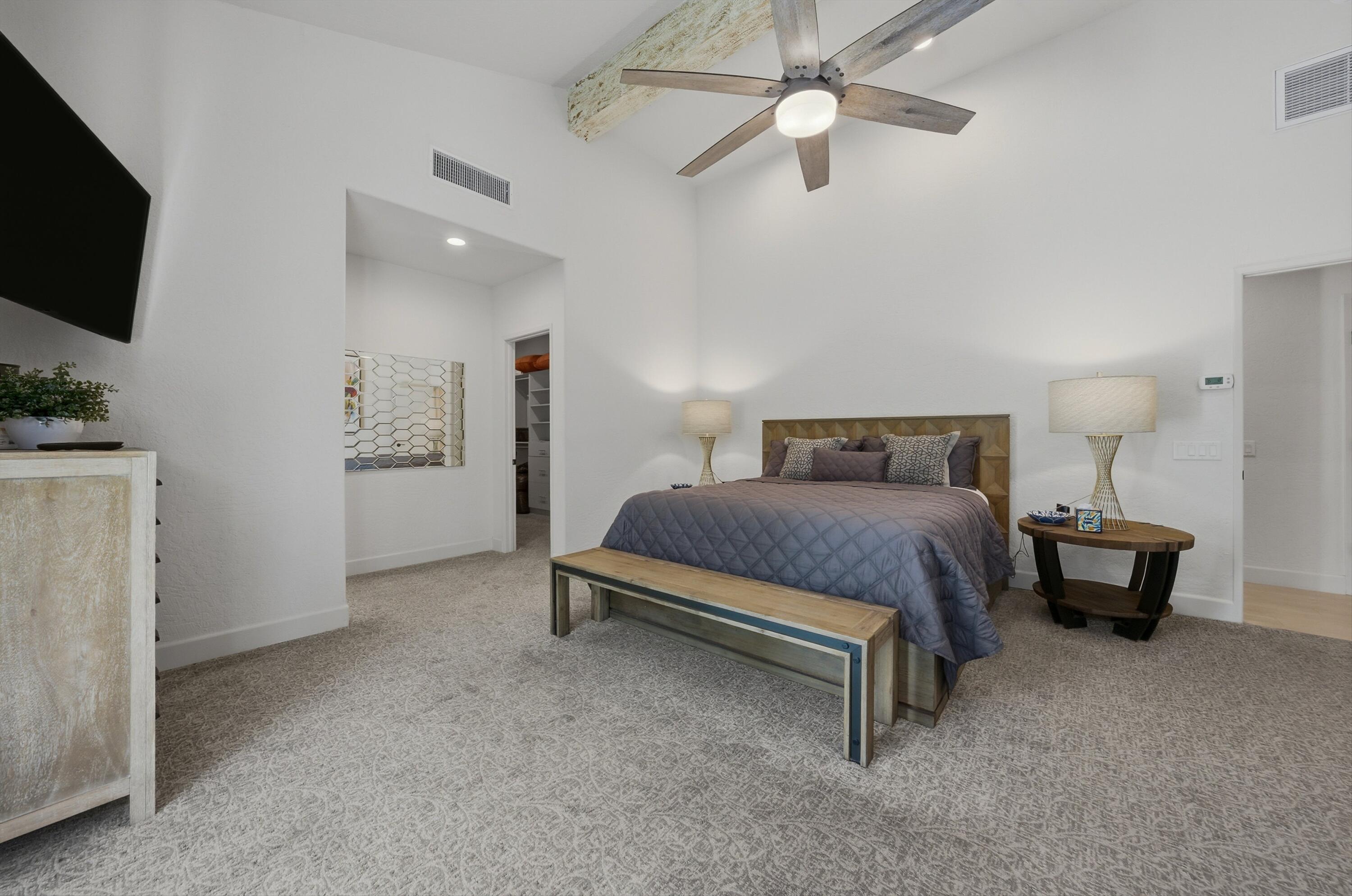 54672 Inverness Way La Quinta, CA 92253 - Photo 32 of 49 a spacious bedroom with a bed and a flat screen tv