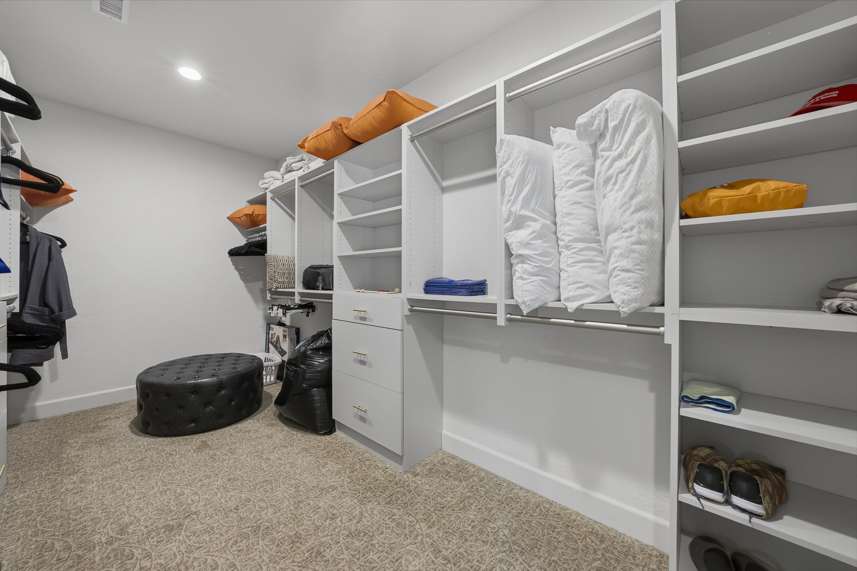 54672 Inverness Way La Quinta, CA 92253 - Photo 37 of 49 a view of walk in closet with clothes and shoes