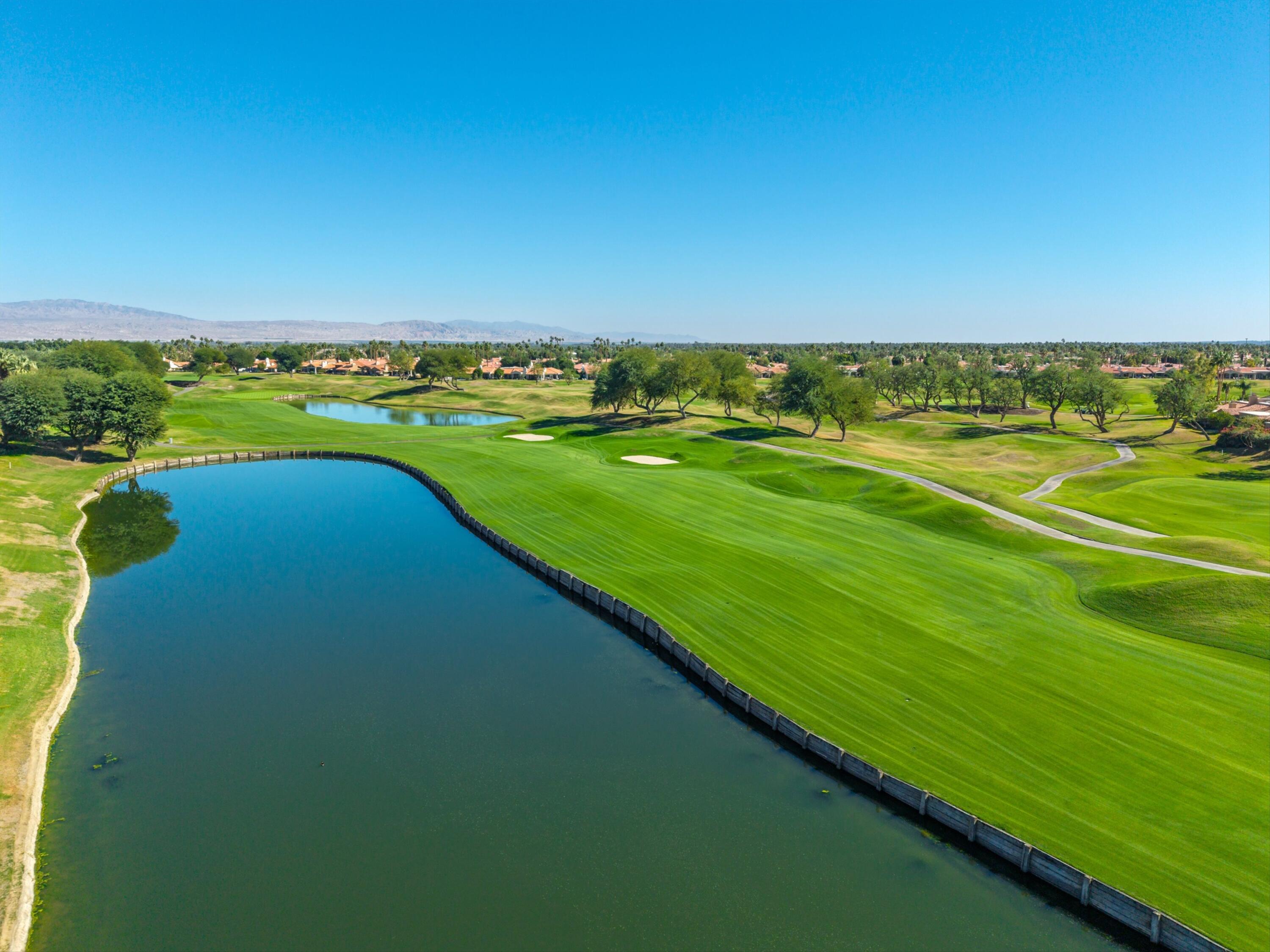 54672 Inverness Way La Quinta, CA 92253 - Photo 44 of 49 a view of a lake with a big yard