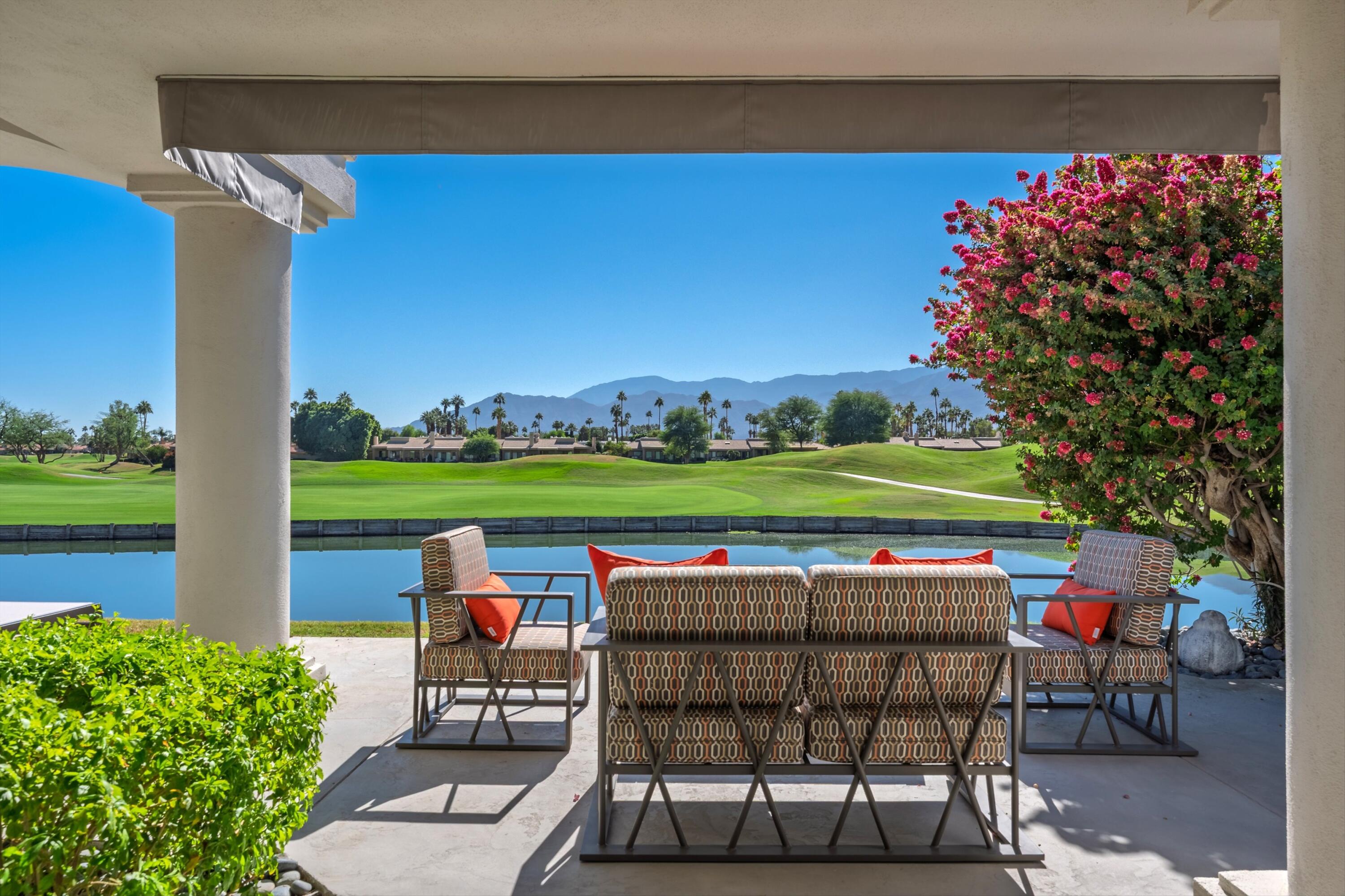 54672 Inverness Way La Quinta, CA 92253 - Photo 48 of 49 a view of a chairs and table in patio with a yard