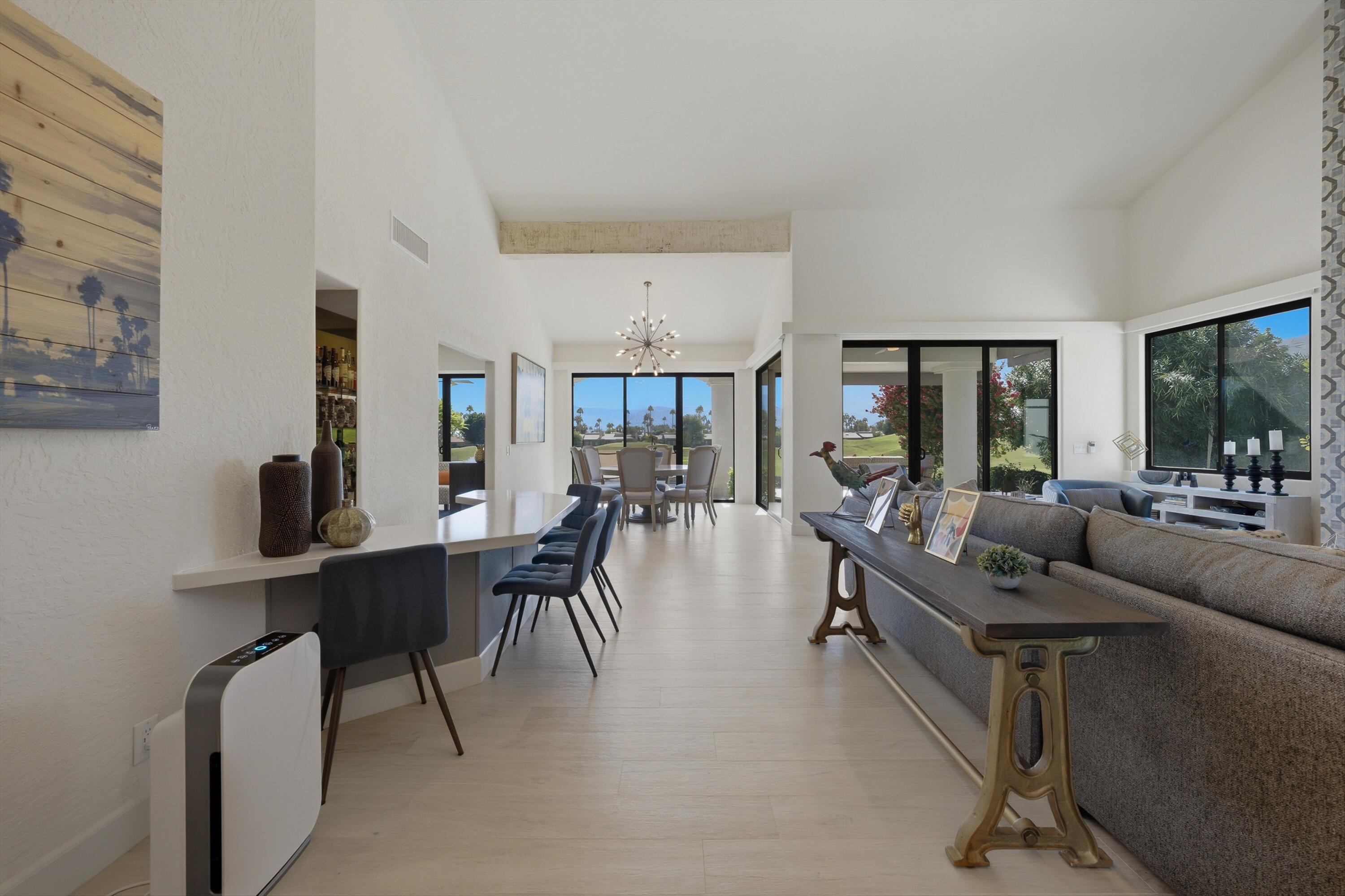 54672 Inverness Way La Quinta, CA 92253 - Photo 10 of 49 a living room with furniture a dining table and a large window