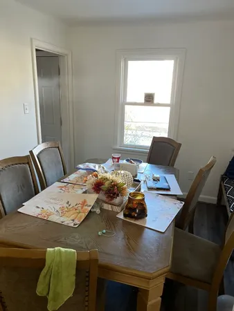a view of a dining room with furniture and a window
