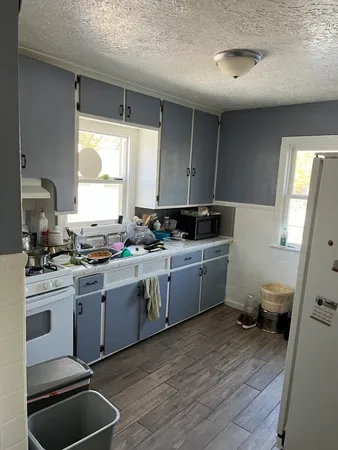 a kitchen with a sink cabinets and window