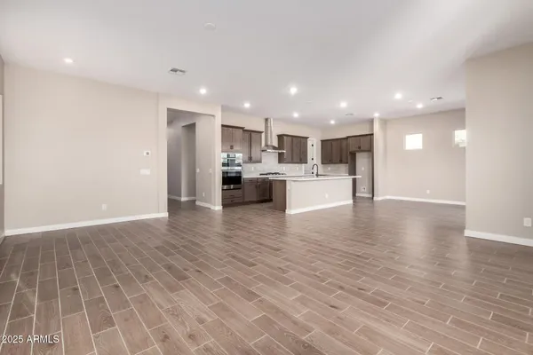 a view of kitchen with kitchen island and stainless steel appliances