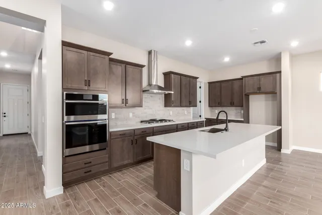 a kitchen with a sink stove and refrigerator