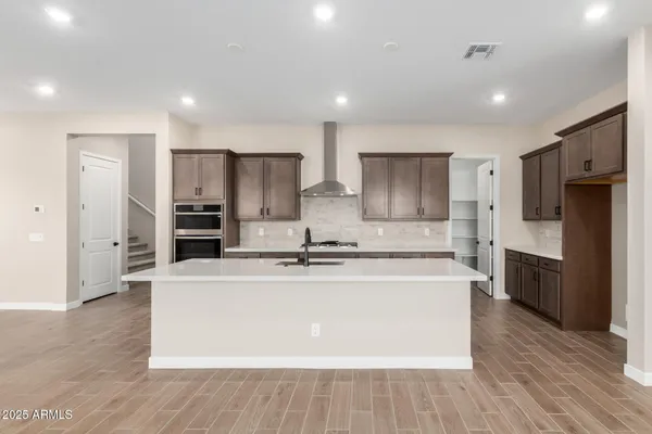 a large kitchen with stainless steel appliances
