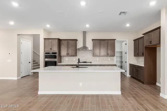 a large kitchen with stainless steel appliances