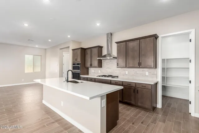 a kitchen with a sink a stove a refrigerator and a refrigerator