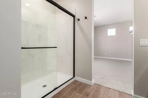 a bathroom with a glass shower door