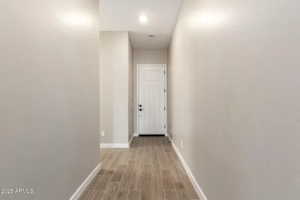 a view of a hallway with wooden floor