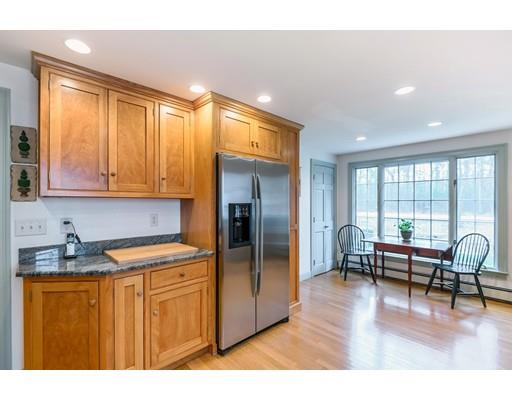 17 Towne Road Boxford, MA 01921 - Photo 6 of 28 a kitchen with stainless steel appliances granite countertop a refrigerator a sink dishwasher a dining table and chairs with wooden floor