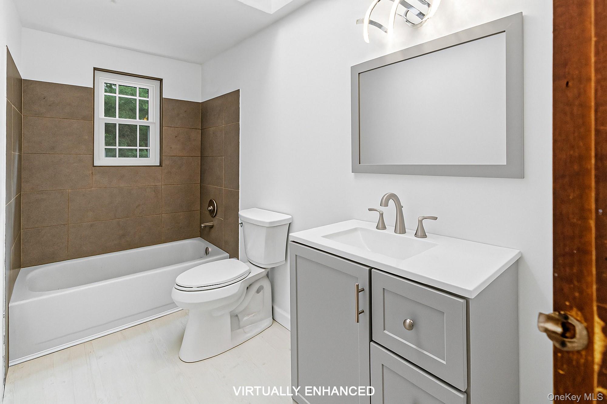 18 Norfolk Drive Springs, NY 11937 - Photo 12 of 26 a bathroom with a sink toilet and shower