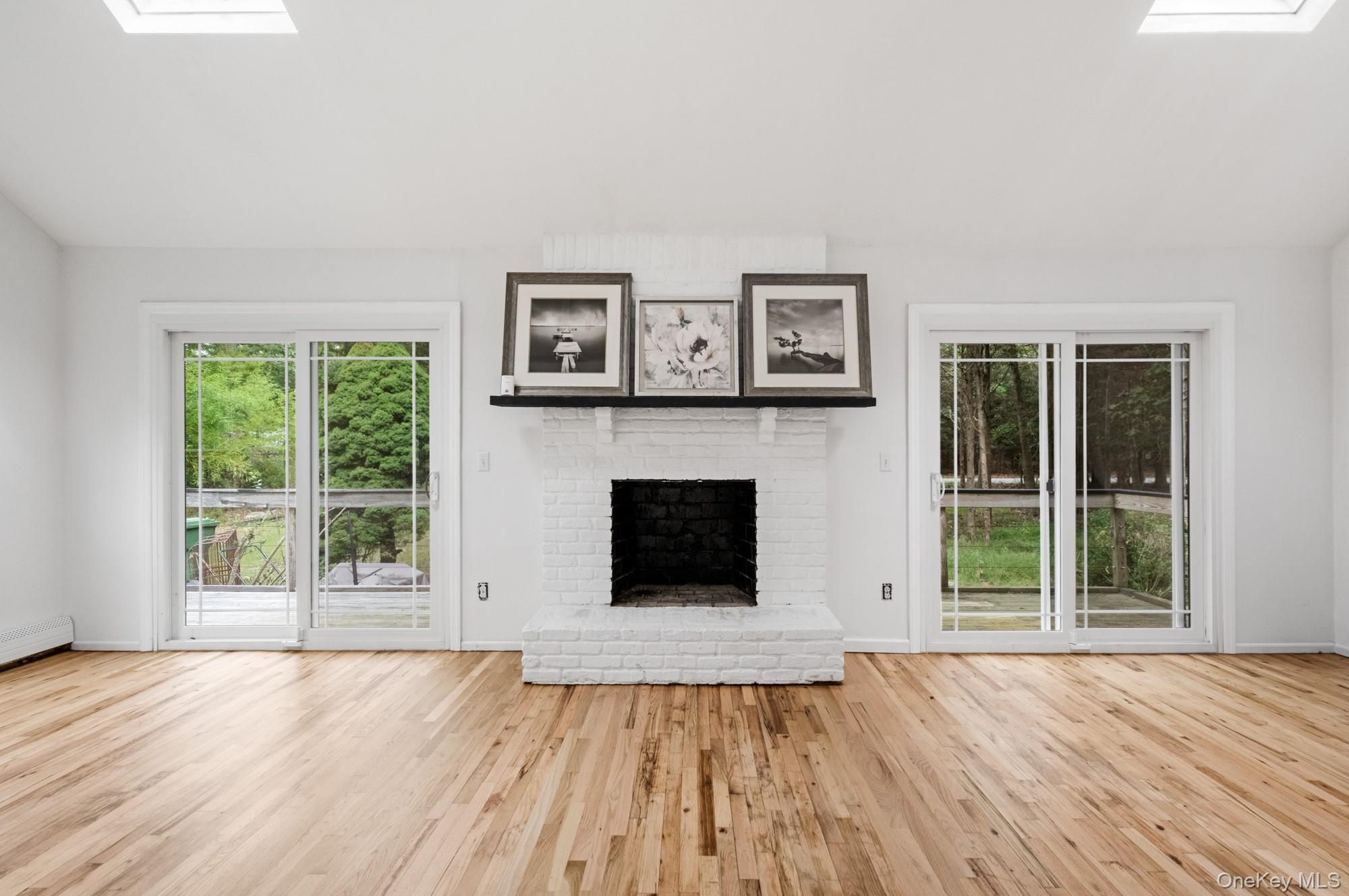 18 Norfolk Drive Springs, NY 11937 - Photo 3 of 26 a view of an empty room with wooden floor and a window