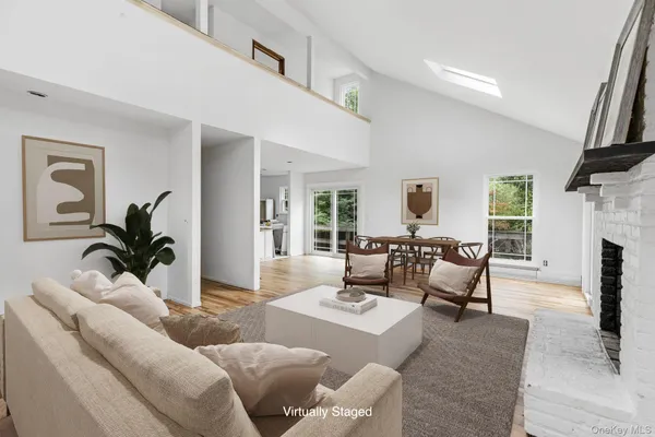 a living room with furniture fireplace and a large window