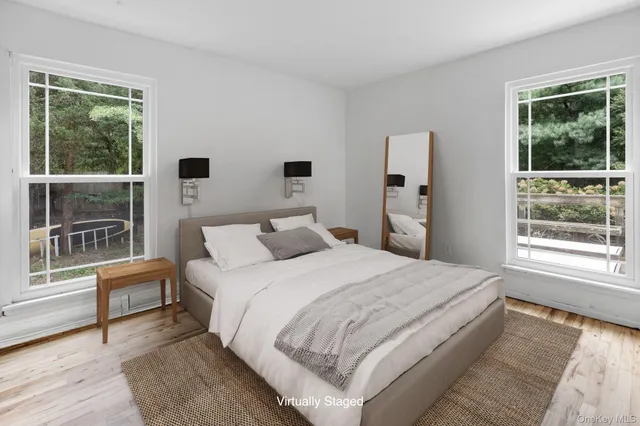 a bedroom with a large bed and a large window