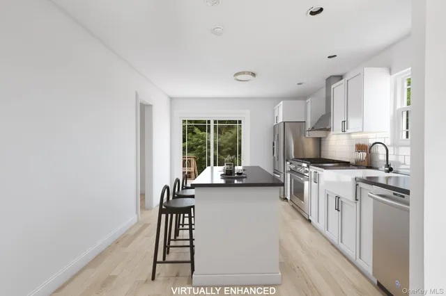 a kitchen with stainless steel appliances granite countertop a stove a sink and a refrigerator