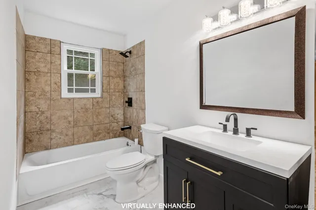 a bathroom with a sink a toilet a mirror a bathtub and shower