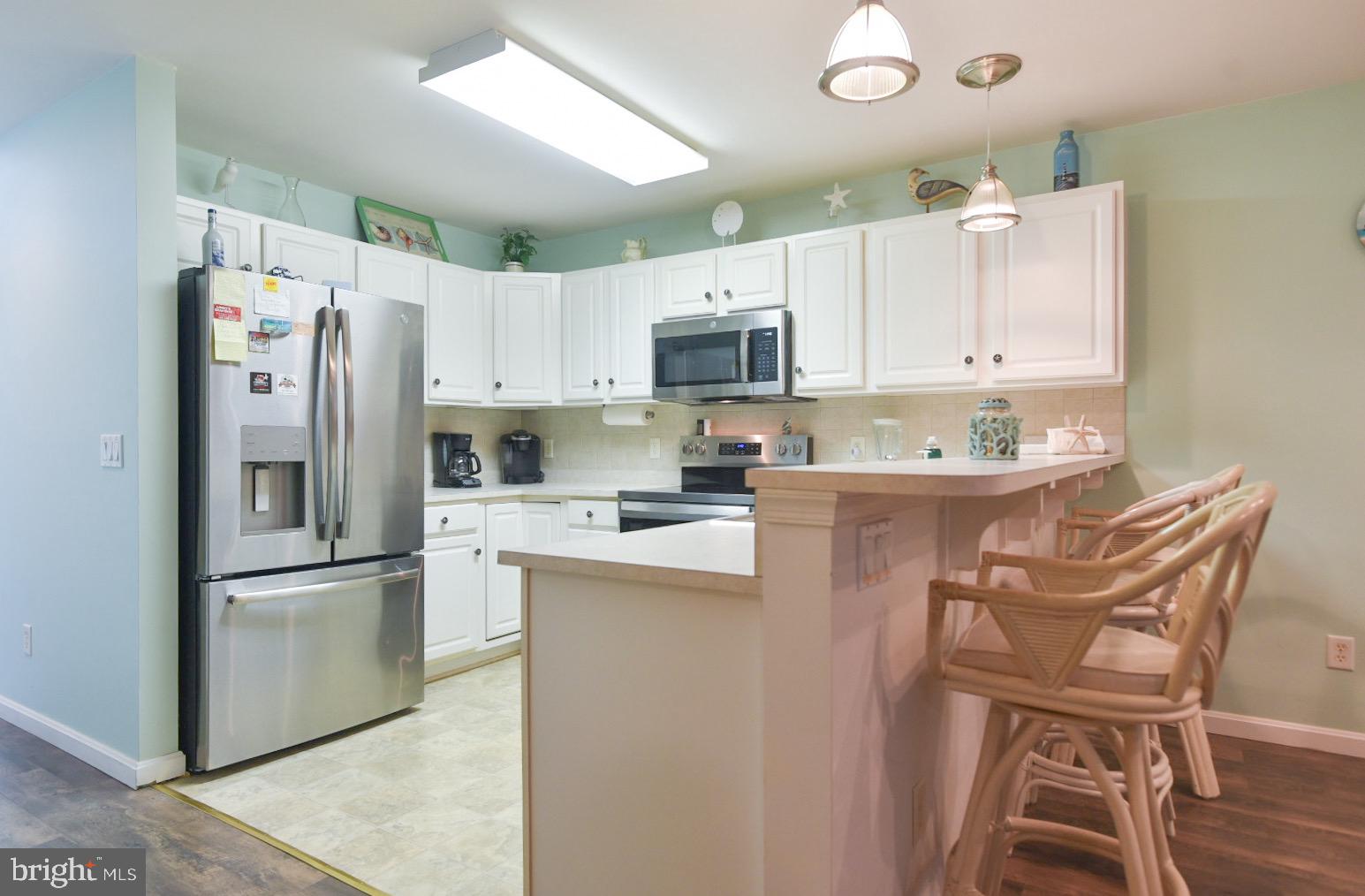 195 Pine Tree Road Ocean City, MD 21842 - Photo 13 of 60 Love the Stainless Steel and White Cabinets