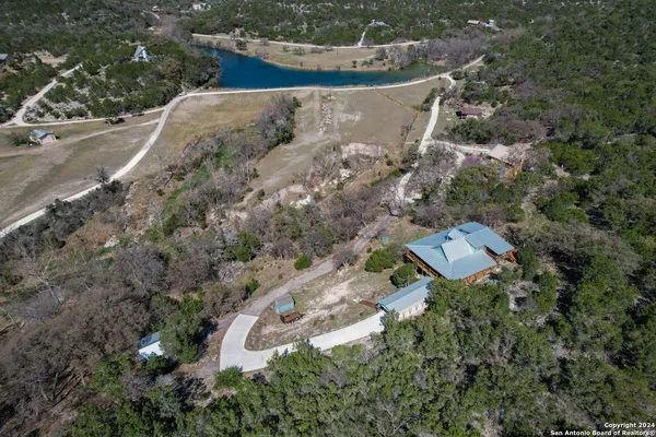 an aerial view of a house with a yard