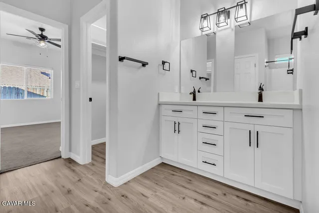 wooden floor with white cabinets