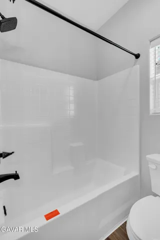 a bathroom with a bathtub and a toilet