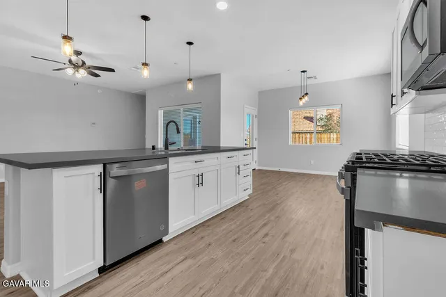a kitchen with a sink appliances and cabinets