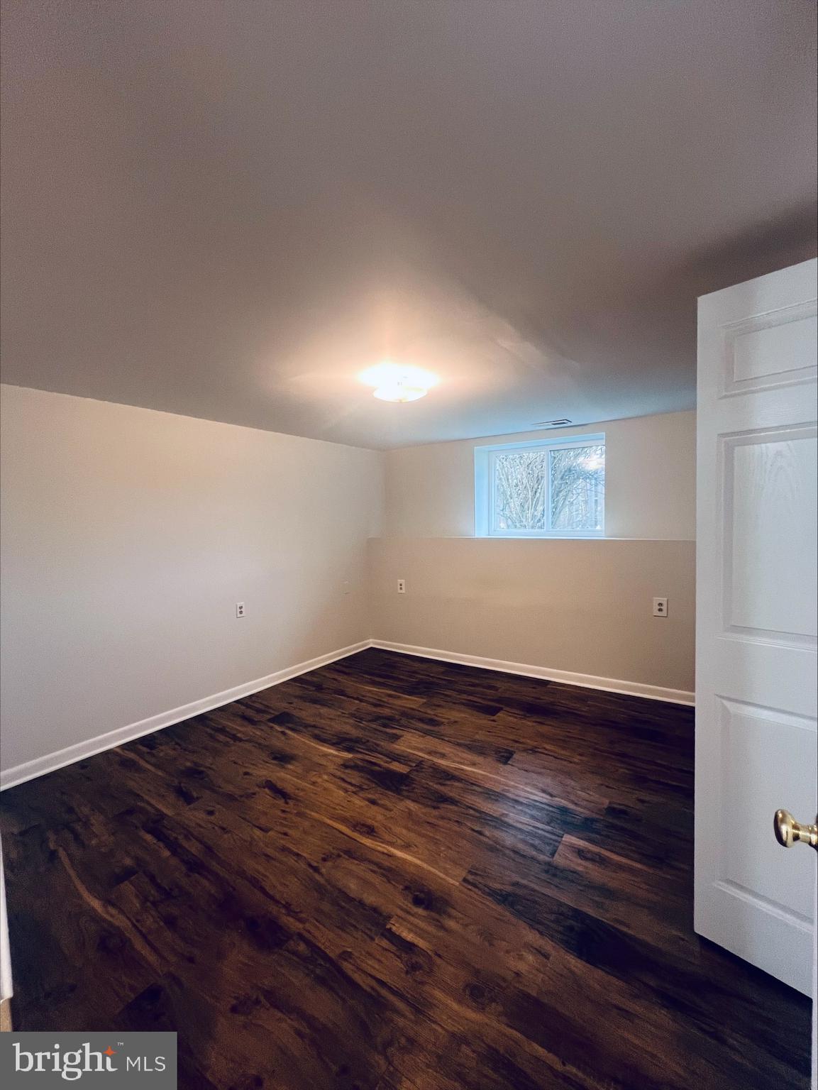 2043 Sue Avenue Baltimore, MD 21221 - Photo 12 of 26 a view of an empty room with wooden floor