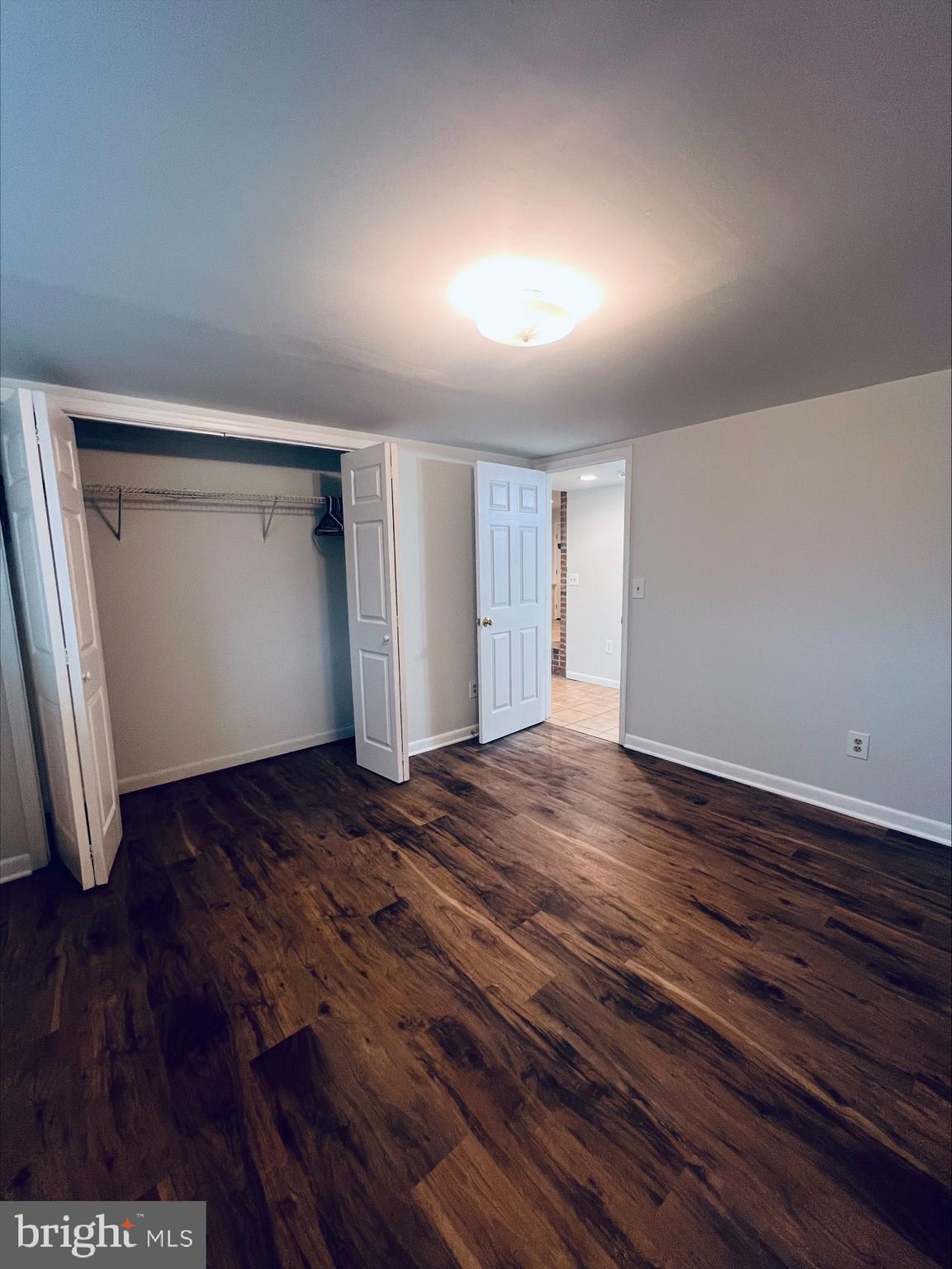 2043 Sue Avenue Baltimore, MD 21221 - Photo 13 of 26 a view of an empty room with wooden floor and closet