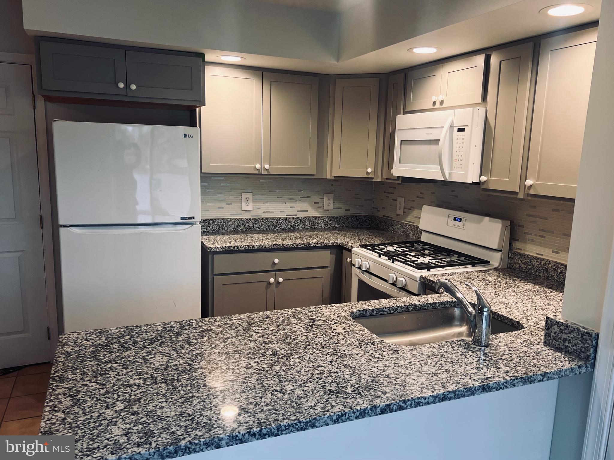 2043 Sue Avenue Baltimore, MD 21221 - Photo 4 of 26 a kitchen with a sink stove and refrigerator
