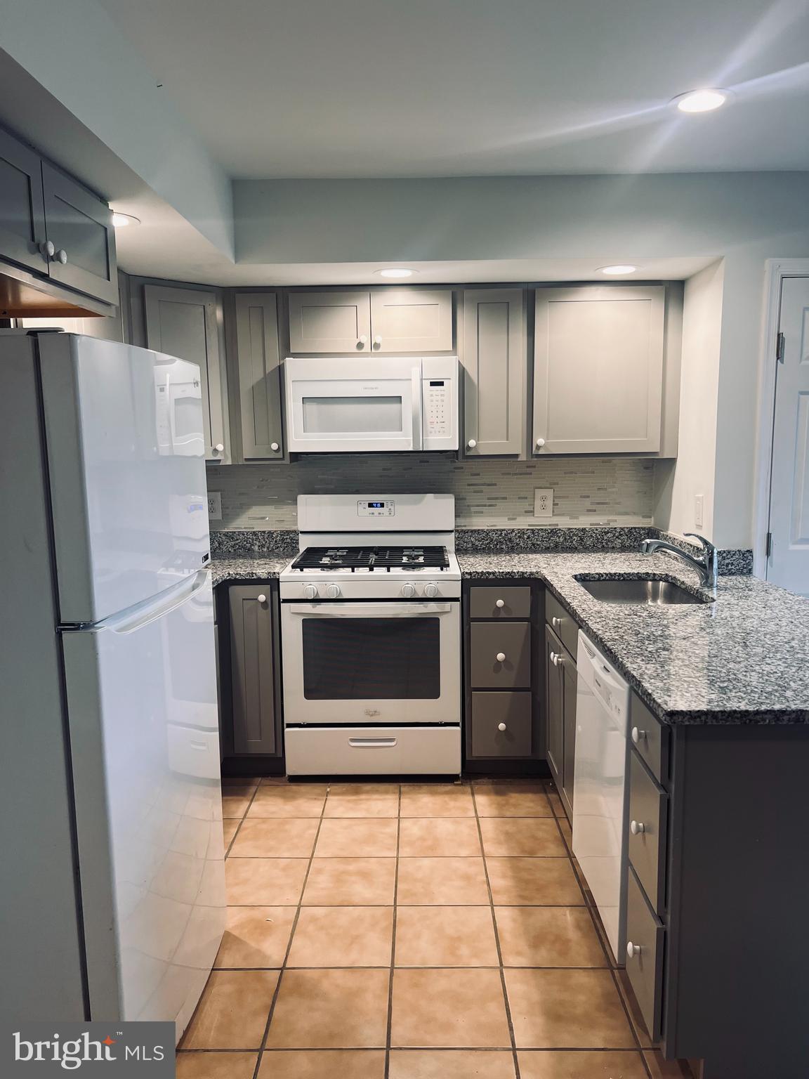 2043 Sue Avenue Baltimore, MD 21221 - Photo 5 of 26 a kitchen with a stove top oven and cabinets
