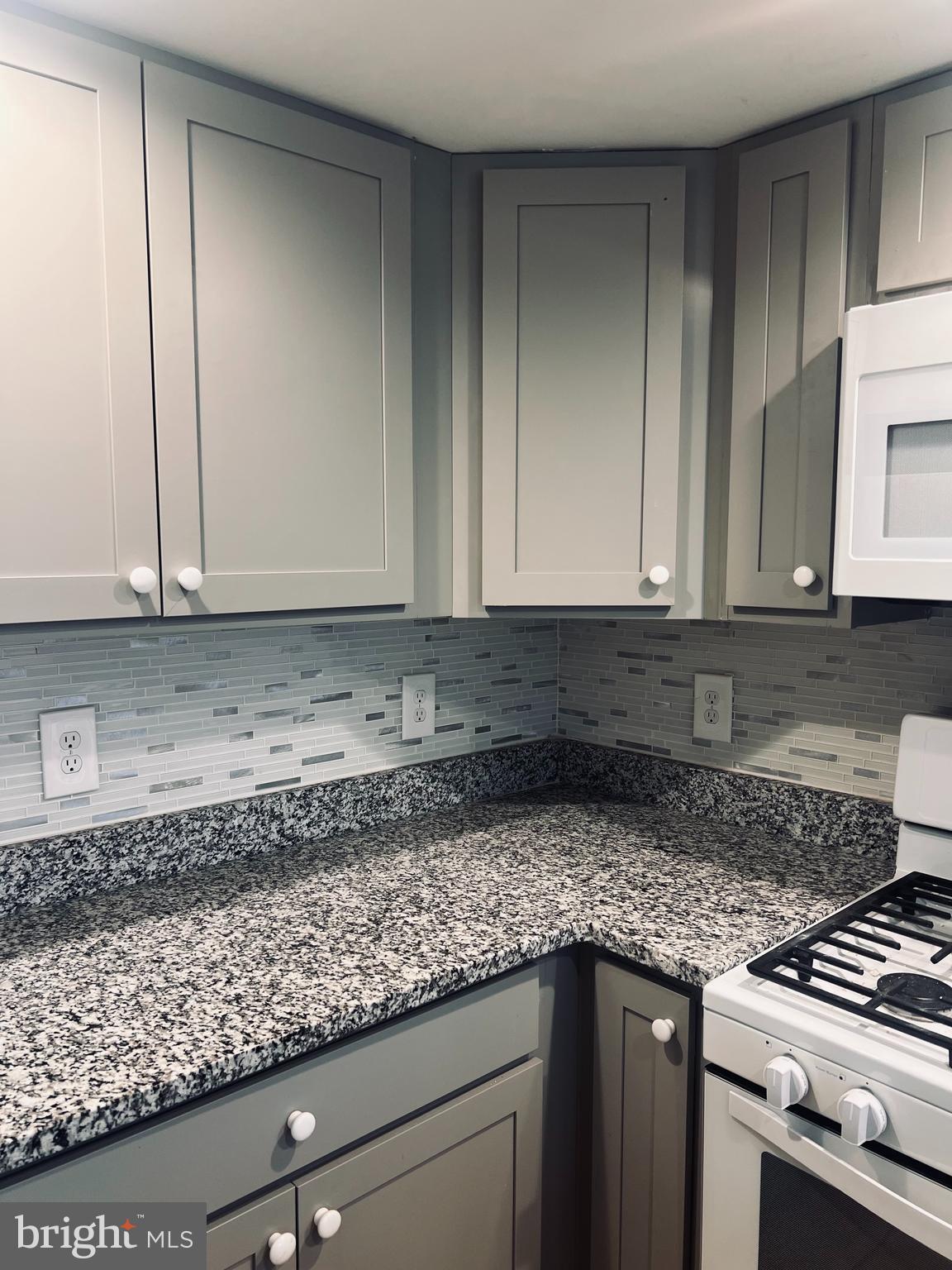 2043 Sue Avenue Baltimore, MD 21221 - Photo 6 of 26 a kitchen with granite countertop a sink and cabinets