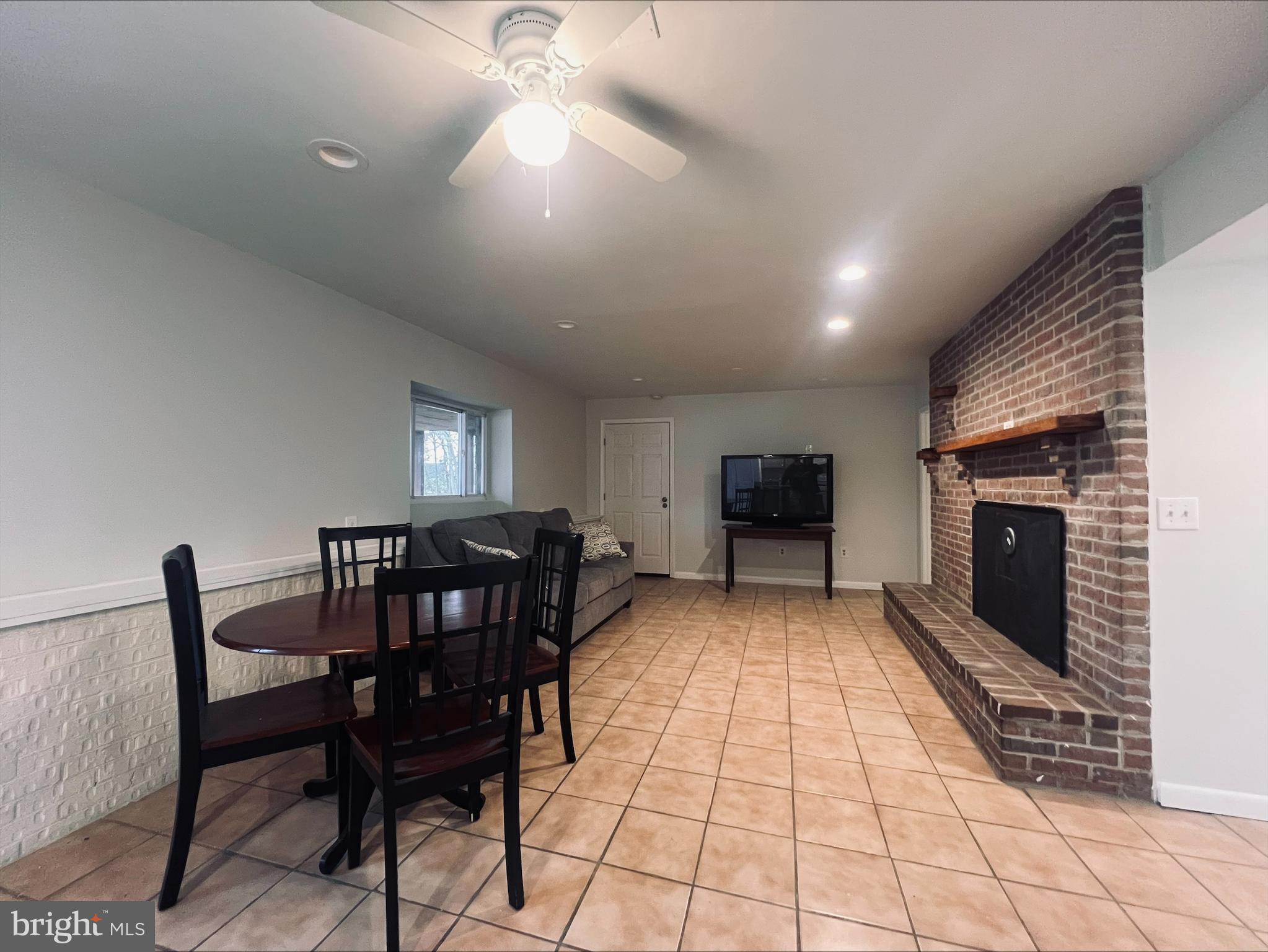2043 Sue Avenue Baltimore, MD 21221 - Photo 8 of 26 a living room with furniture a flat screen tv and kitchen view