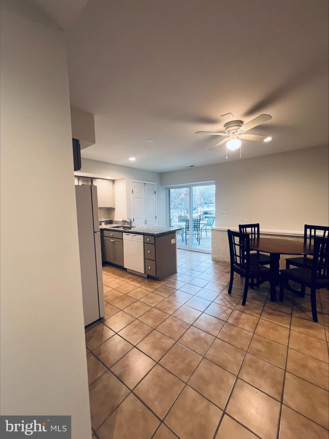 2043 Sue Avenue Baltimore, MD 21221 - Photo 9 of 26 a kitchen with stainless steel appliances kitchen island granite countertop a refrigerator and a sink