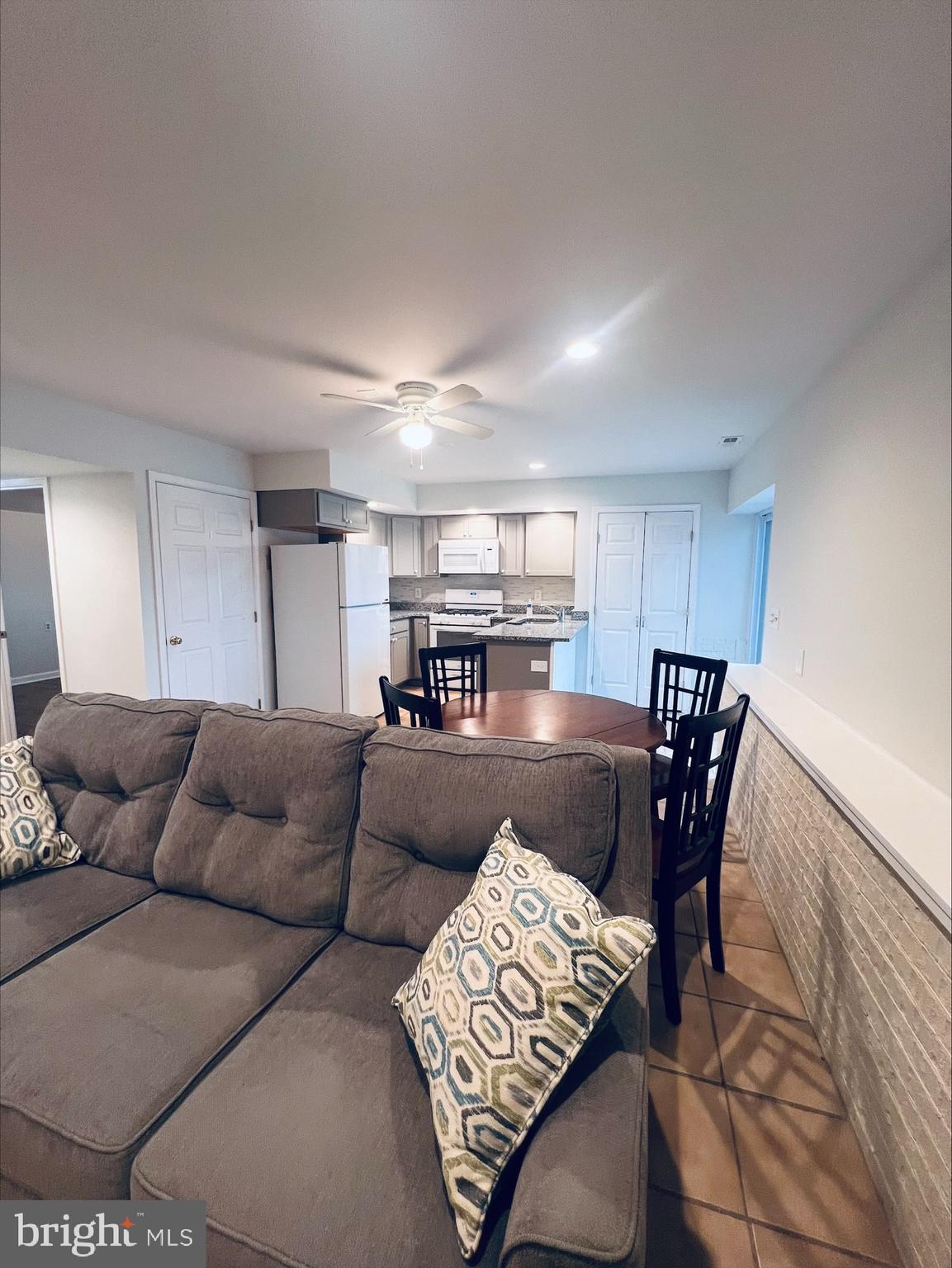 2043 Sue Avenue Baltimore, MD 21221 - Photo 10 of 26 a living room with furniture and a dining table with kitchen view
