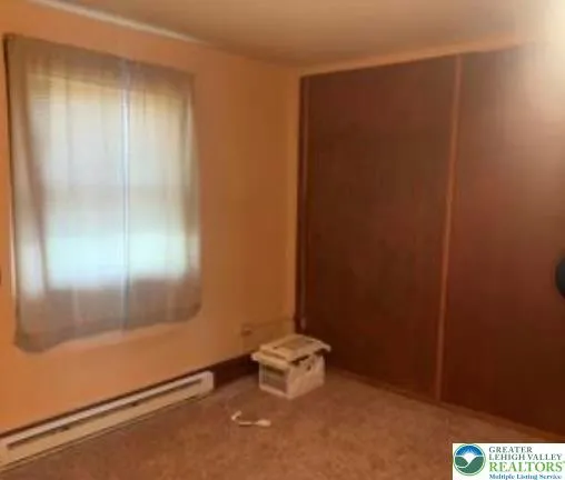 a view of an empty room and a window