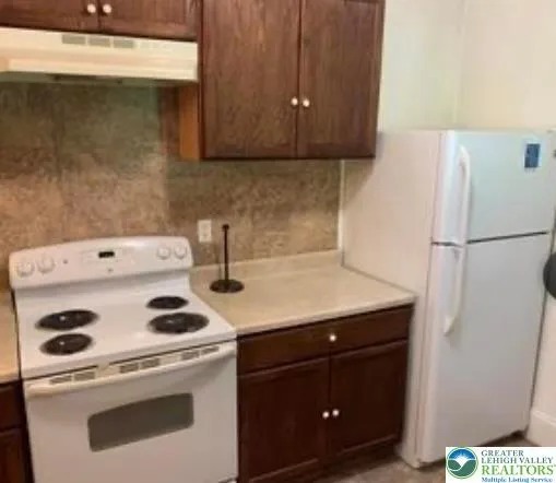 a kitchen with a stove and a refrigerator