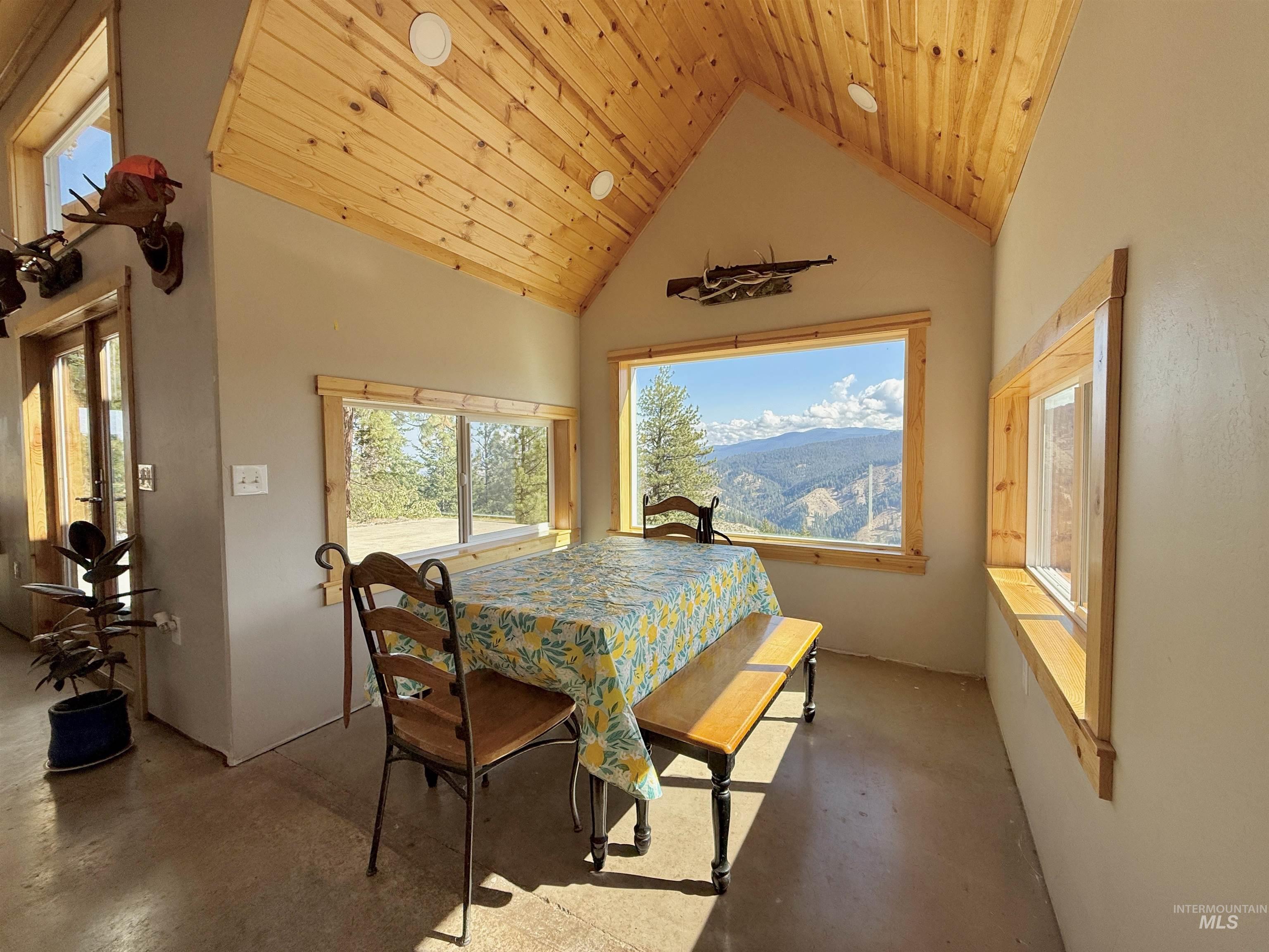 929 Mt Idaho Grade Road Grangeville, ID 83530 - Photo 11 of 47 Dining area featuring high vaulted ceiling, plenty of natural light, wooden ceiling, and concrete floors