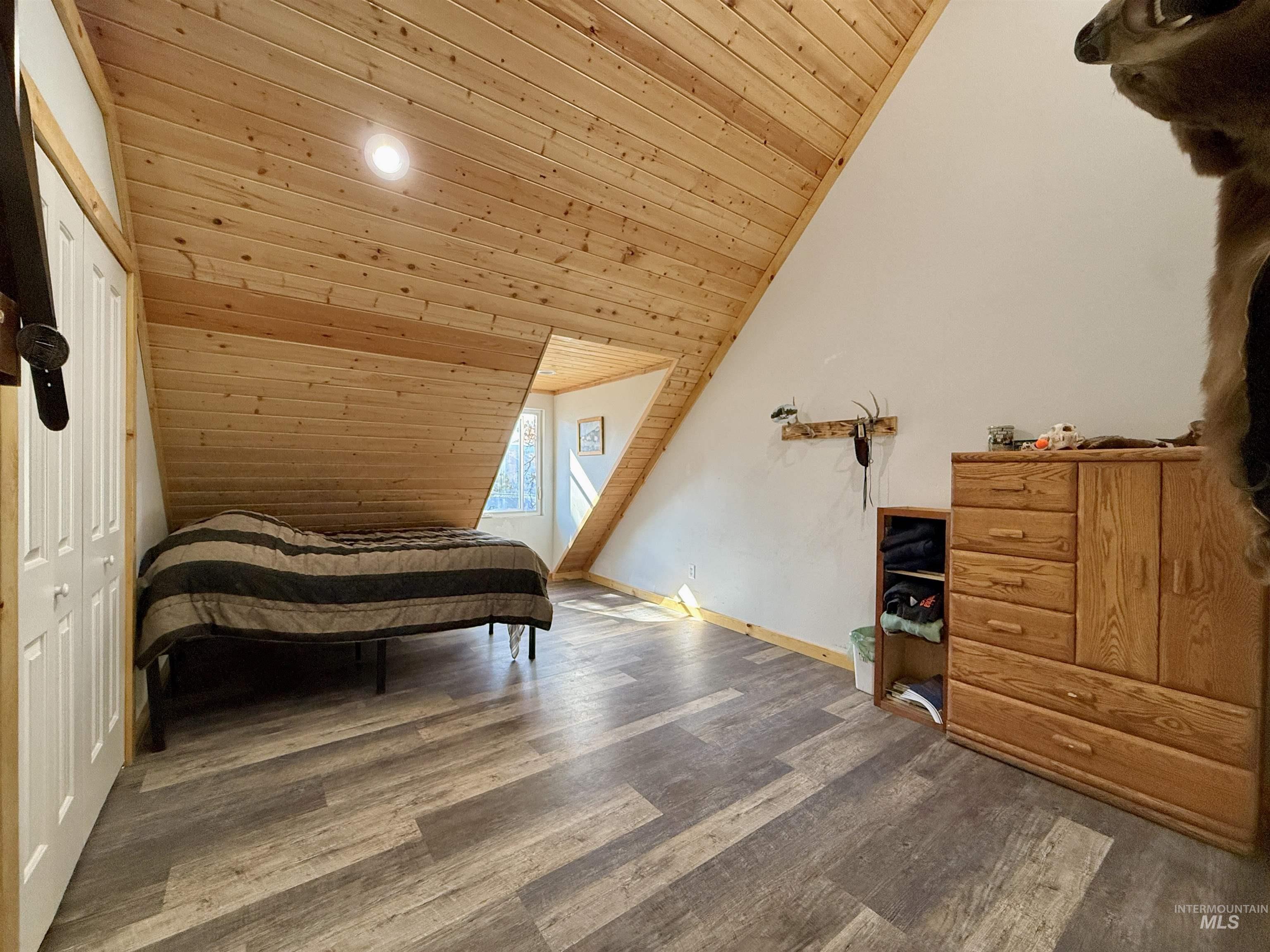 929 Mt Idaho Grade Road Grangeville, ID 83530 - Photo 19 of 47 Bedroom with wood ceiling, vaulted ceiling, wood finished floors, a closet, and recessed lighting