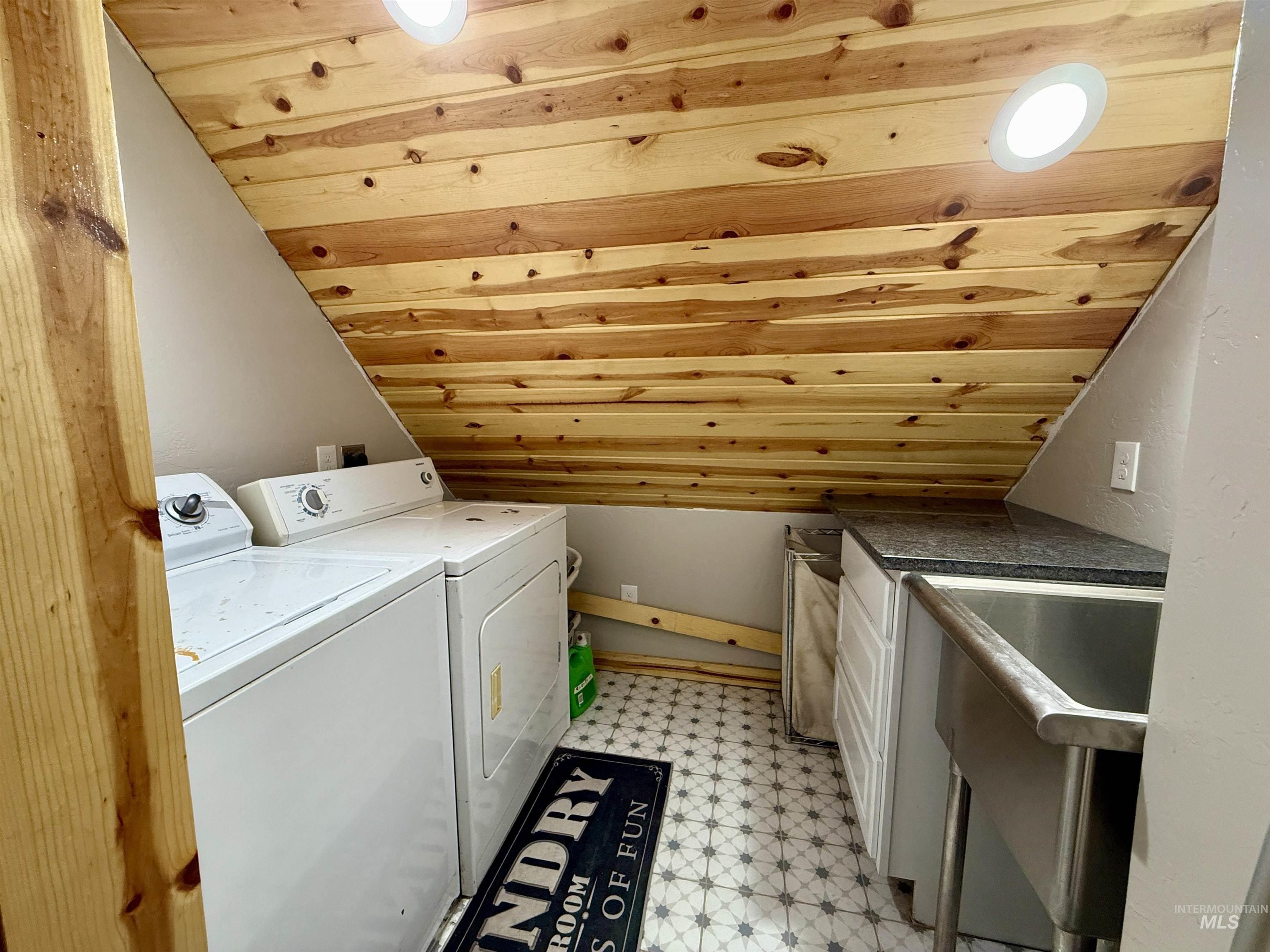 929 Mt Idaho Grade Road Grangeville, ID 83530 - Photo 21 of 47 Washroom featuring wood ceiling, washing machine and clothes dryer, and light flooring