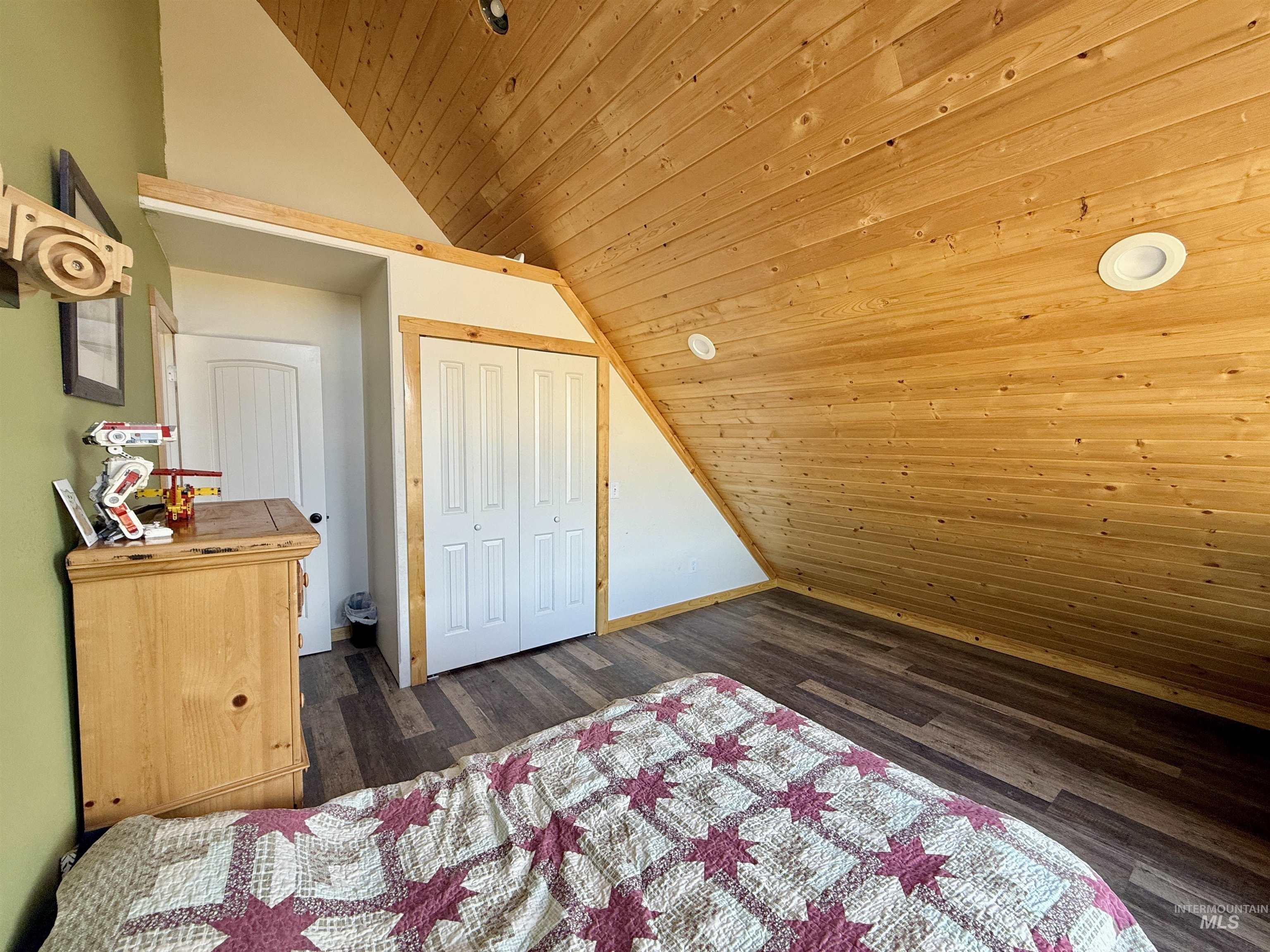 929 Mt Idaho Grade Road Grangeville, ID 83530 - Photo 25 of 47 Bedroom featuring wooden ceiling, vaulted ceiling, dark wood-style floors, and a closet