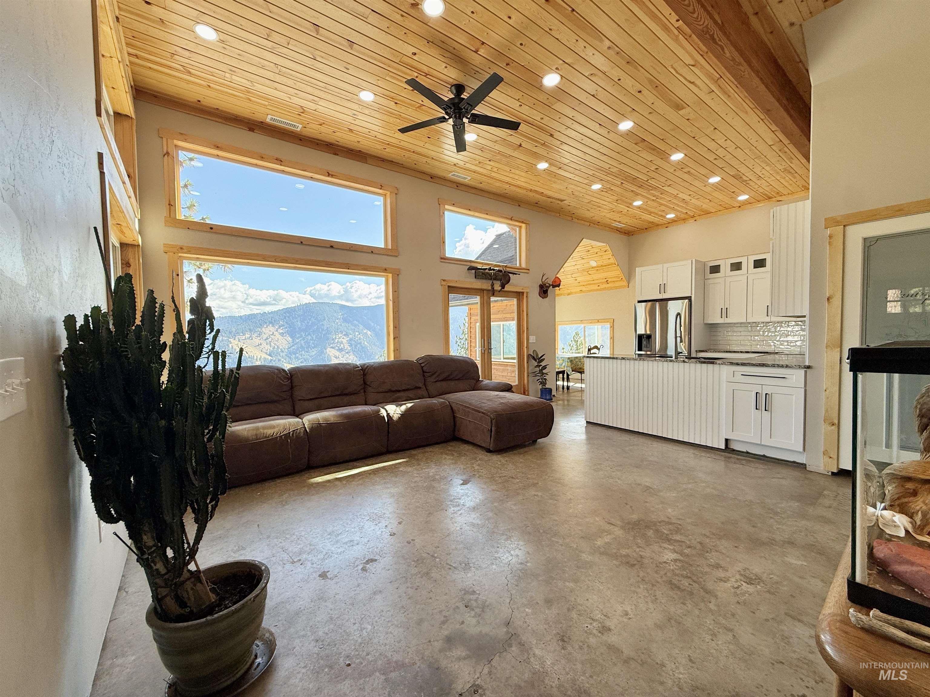 929 Mt Idaho Grade Road Grangeville, ID 83530 - Photo 5 of 47 Living room with wood ceiling, concrete floors, recessed lighting, a towering ceiling, and a ceiling fan
