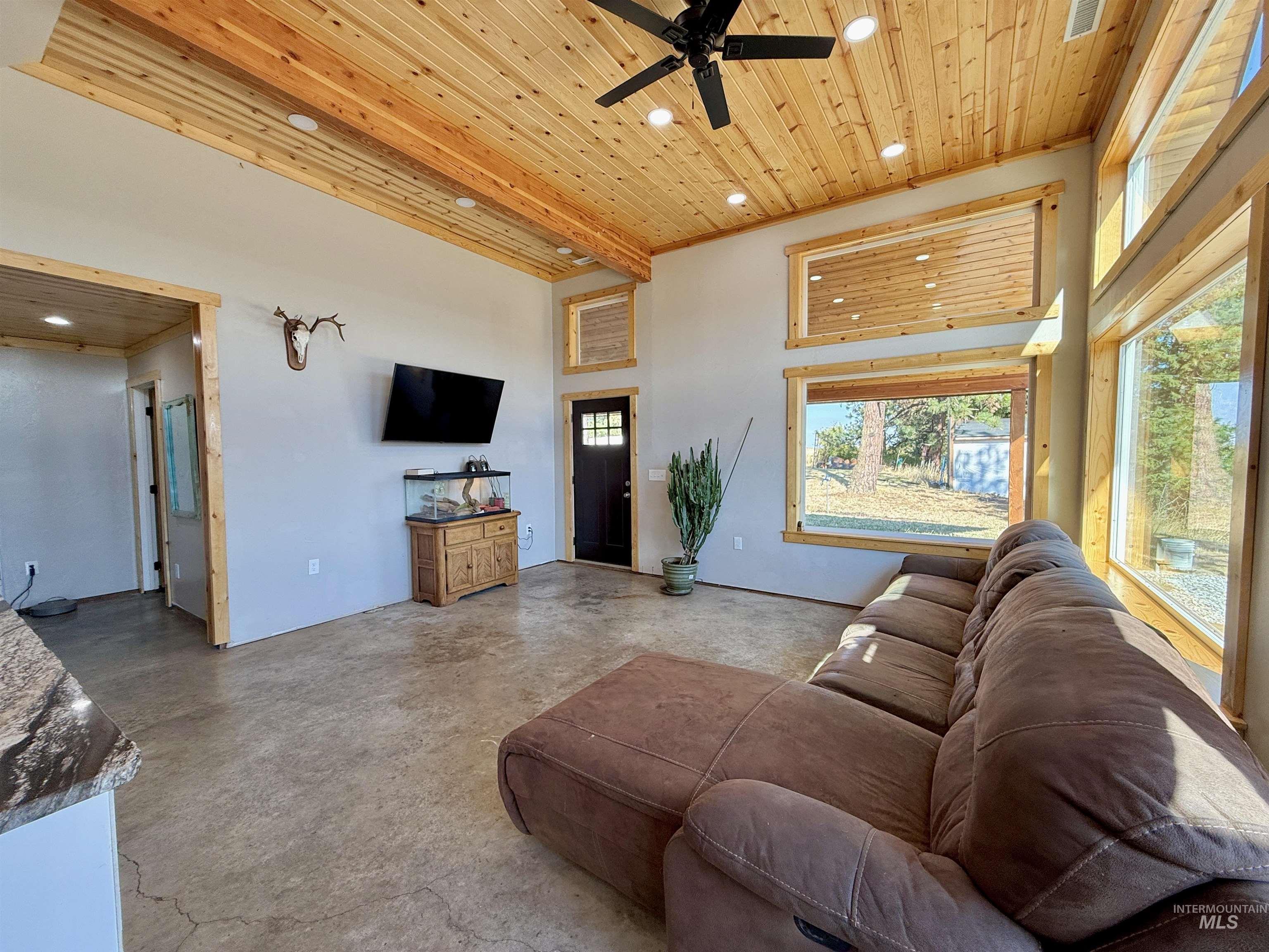929 Mt Idaho Grade Road Grangeville, ID 83530 - Photo 7 of 47 Living room with wooden ceiling, recessed lighting, concrete flooring, a ceiling fan, and a towering ceiling