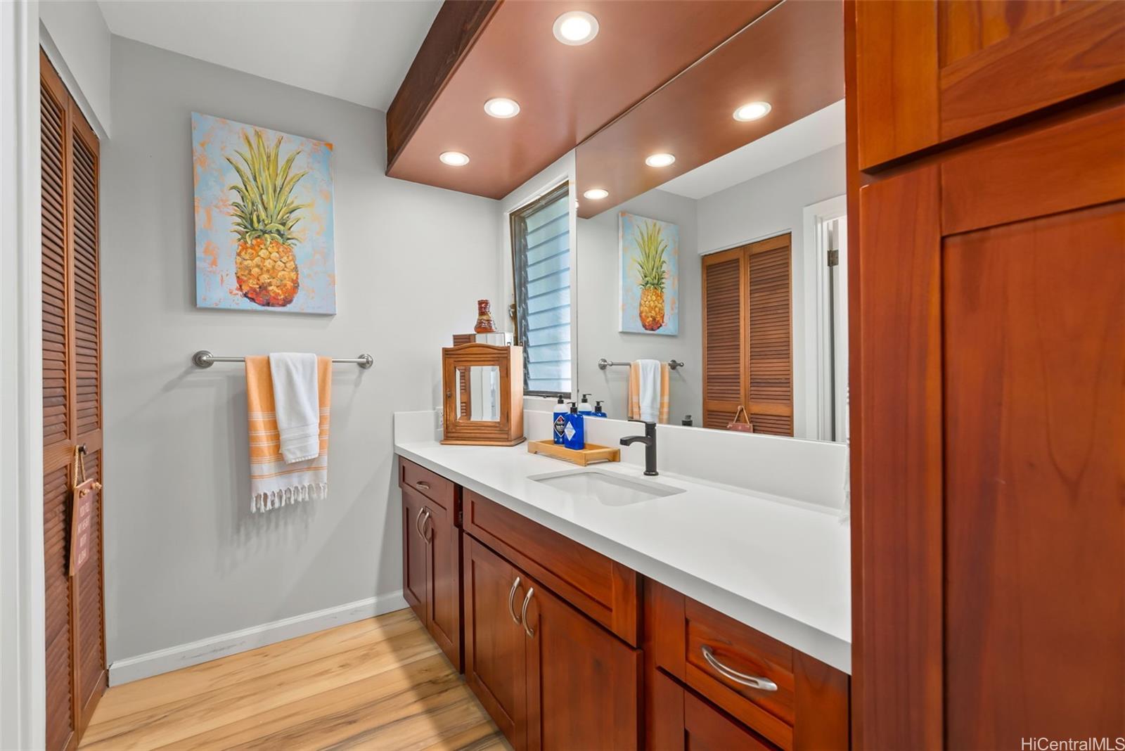 1868 Kihi Street Honolulu, HI 96821 - Photo 20 of 20 a bathroom with a sink a mirror and a shower