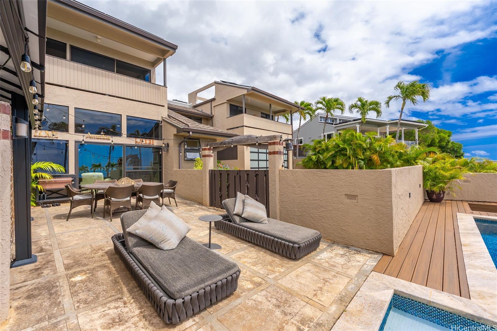 1868 Kihi Street Honolulu, HI 96821 - Photo 10 of 20 a view of a patio with couches table and chairs with wooden floor and fence