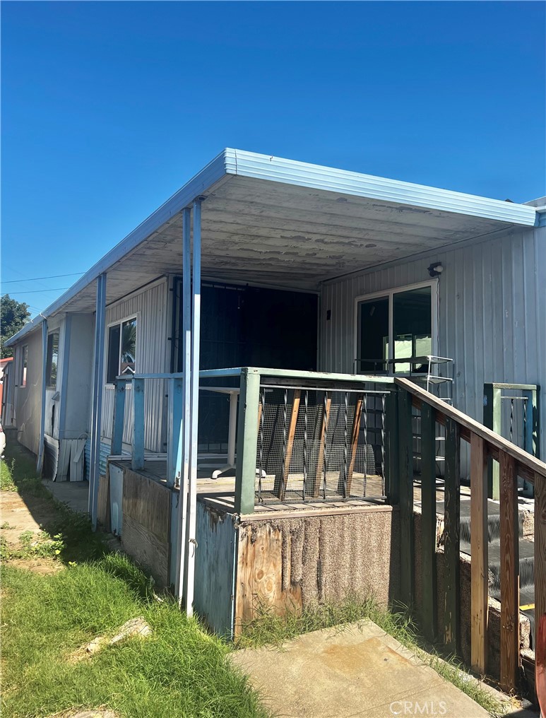 a view of small house with wooden floor and backyard